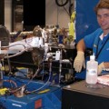damage process in nanometer-sized clusters of atoms is slower than expected from previous studies of atoms and simple molecules
