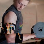 electronic trainer gives bulging biceps