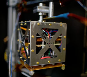 small satellite inside a vacuum chamber simulates space-like conditions