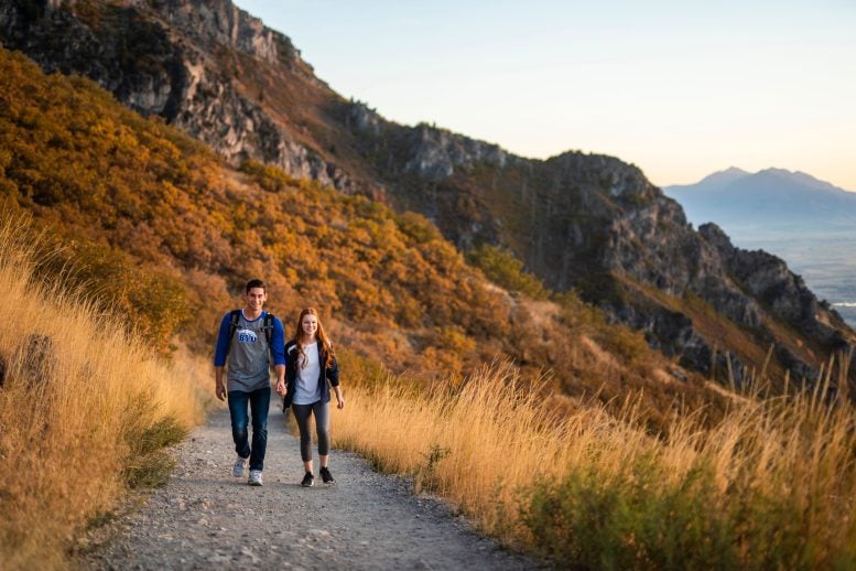 A Couple Walks Along a Mountain Trail