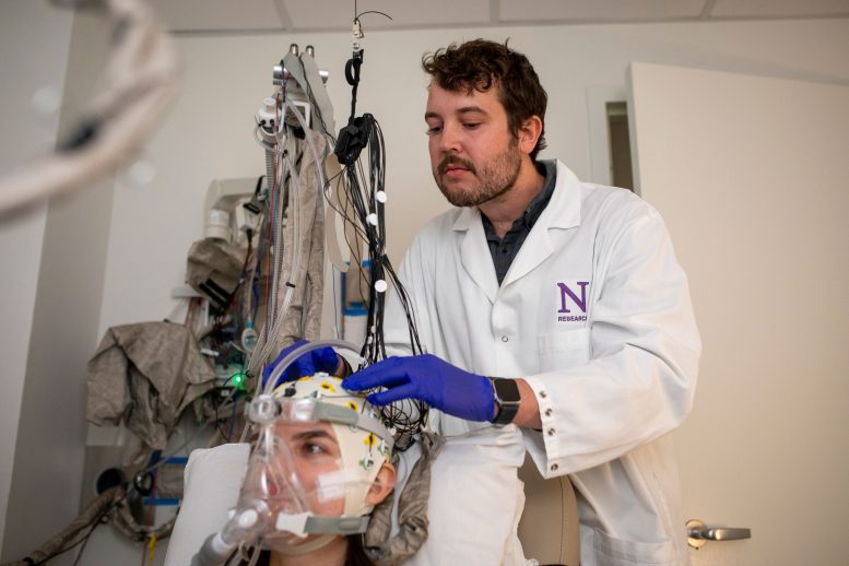 Andrew Sheriff Adjusts a Study Participant&rsquo;s EEG Cap