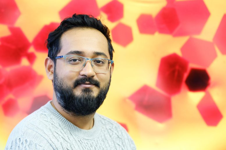 Ankur in Front of a Microscopic Image of Pentasilacyclopentadienide