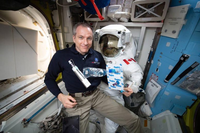 Astronaut David Saint-Jacques collects samples