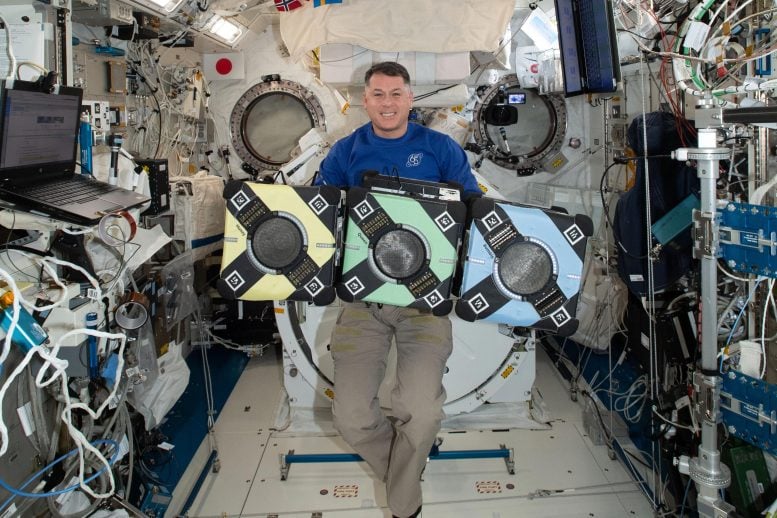 Astronaut Shane Kimbrough Poses With Astrobees