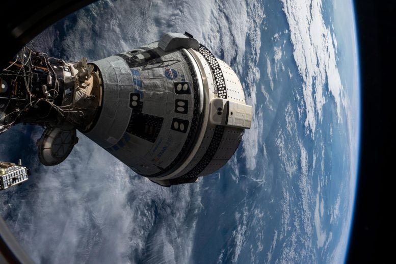 Boeing Starliner Spacecraft Docked to the Harmony Module From a Window on the SpaceX Dragon Endeavour