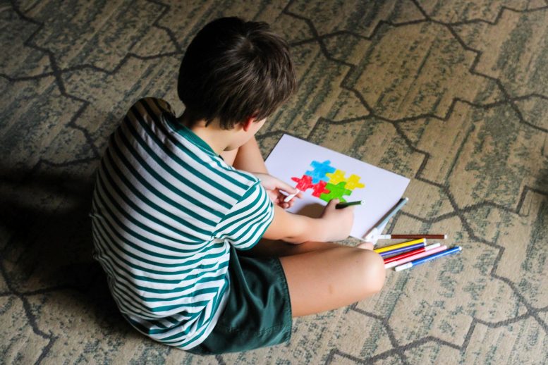 Boy Drawing Colored Autism Symbol