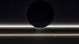 Cassini Image of Enceladus Drifting By Saturn's Rings
