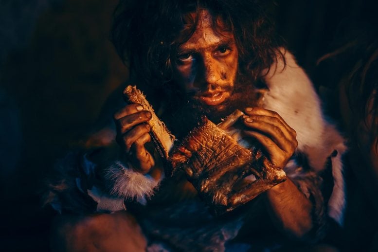 Caveman eating meat