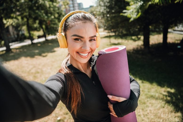Cheerful Smiling Young Woman Athletic Yoga Mat