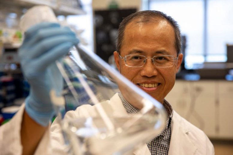 Chenming Zhang Holding a Flask