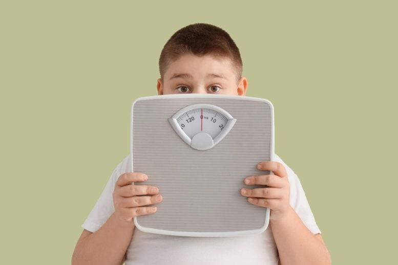 Childhood Obesity Overweight Boy Behind Scale