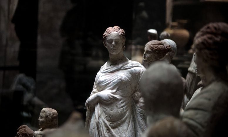 Collection of Ancient Roman Statues Displayed in a Dark Museum Setting.