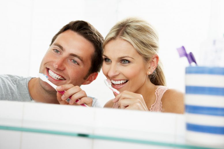 Couple Brushing Teeth