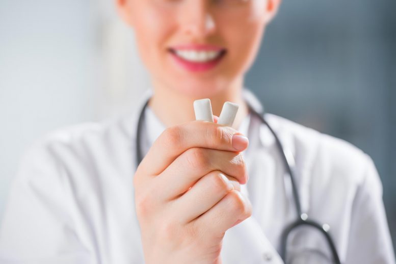 Dentist Holding Chewing Gum