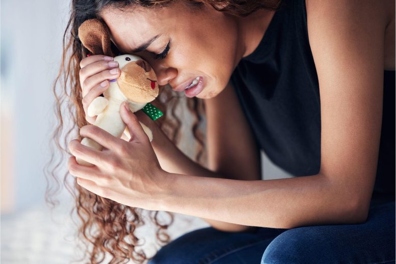 Depressed Woman Holding Stuffed Animal Miscarriage