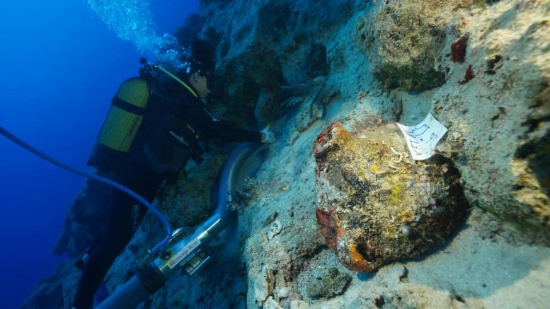 Diver Excavating Pottery at Underwater Archaeological Site