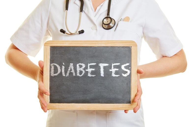 Doctor Holding Diabetes Blackboard