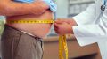 Doctor Measuring Waist Obese Man