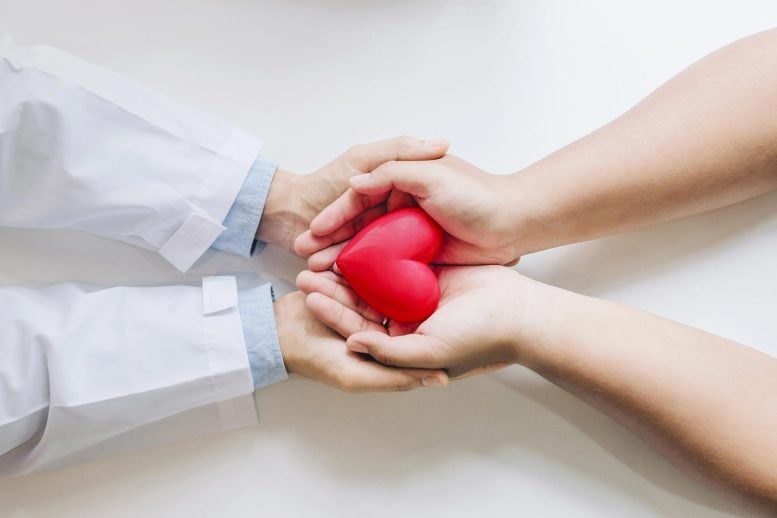 Doctor and Patient Holding Heart