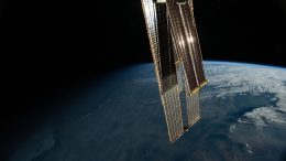 First Rays of an Orbital Sunrise Reflect off the Space Station’s Roll-Out Solar Arrays