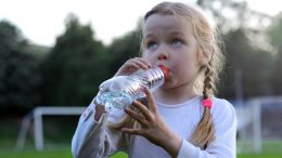 Girl Drinking From Plastic Water Bottle