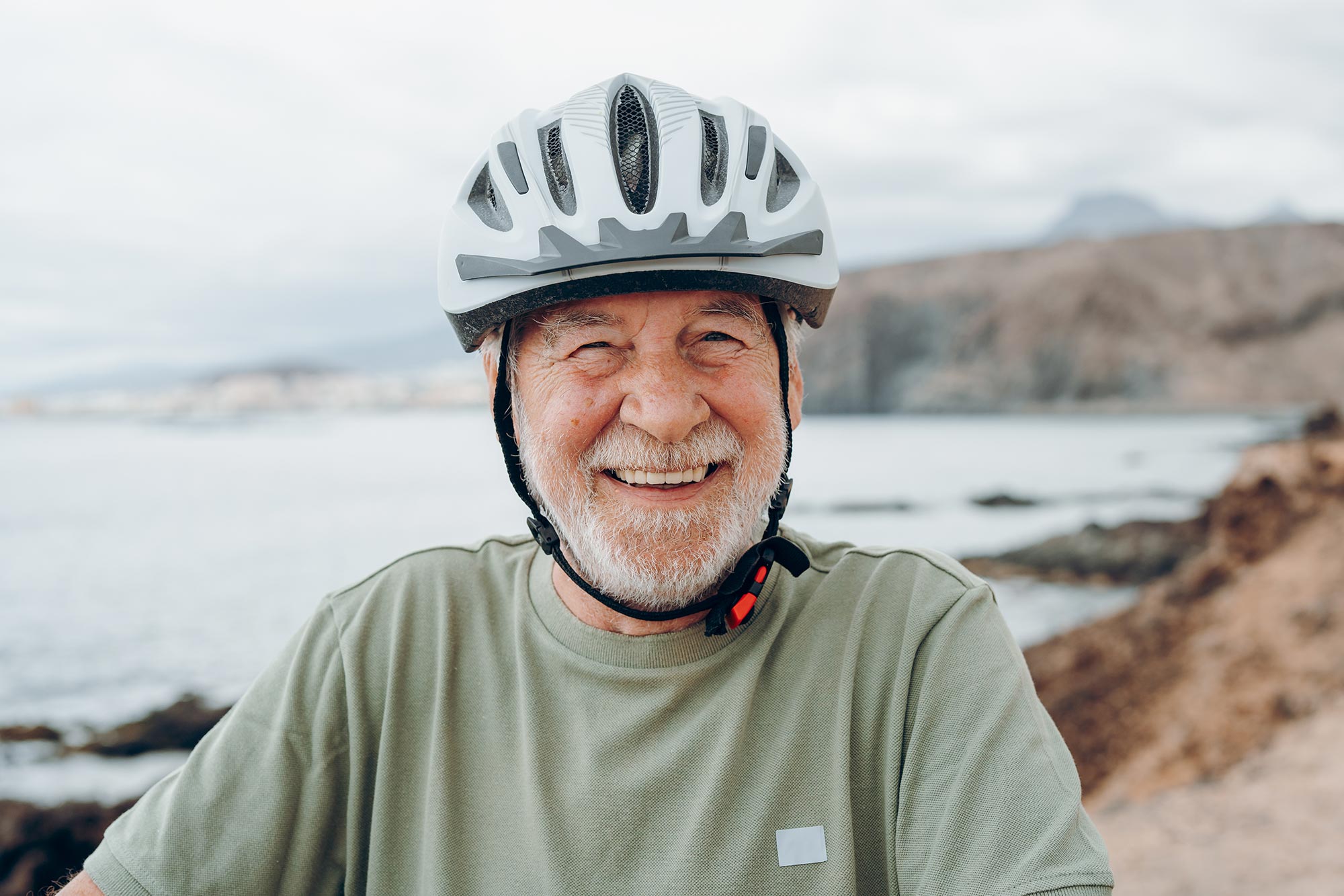 Happy senior man cycling for health