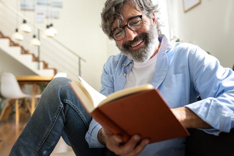 Happy Senior Man Reading Book