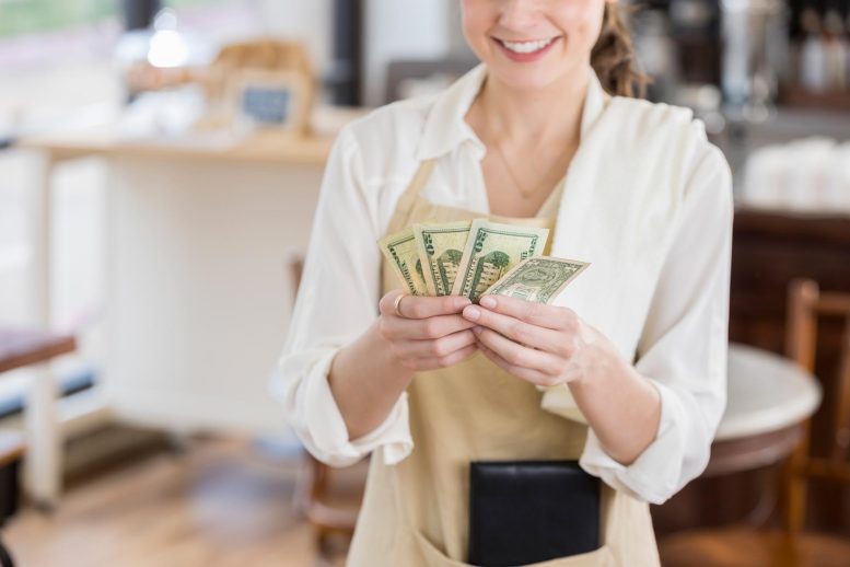 Happy Waitress With Big Cash Tip