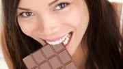 Happy Woman Eating Large Chocolate Bar