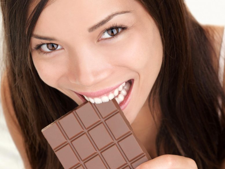 Happy Woman Eating Large Chocolate Bar