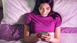 Happy Woman Smartphone Bed