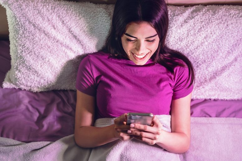Happy Woman Smartphone Bed
