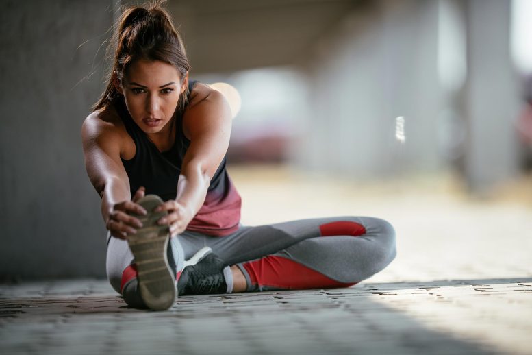 Healthy Female Athlete Stretching