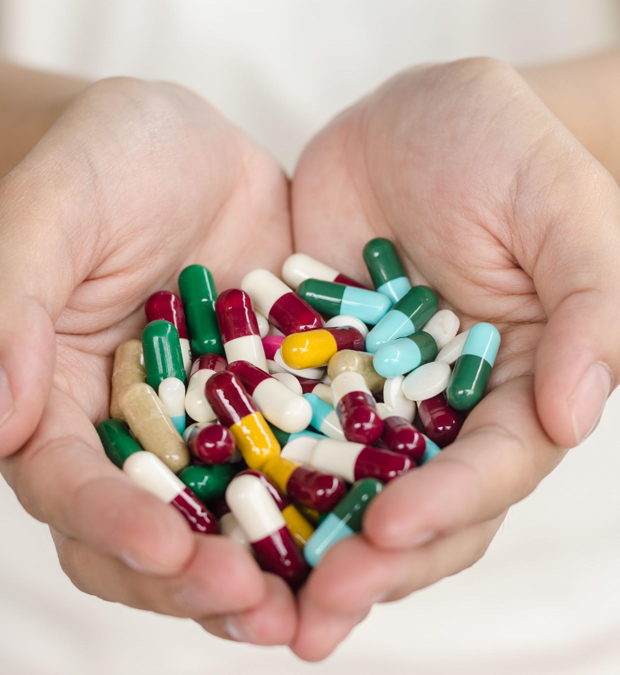 Holding Various Medicines Pills Drugs
