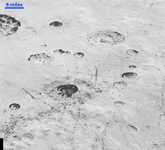 Layered Craters and Icy Plains of Pluto