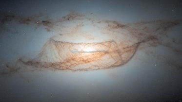 Hubble’s Sharpest View: A Lenticular Galaxy’s Dust and Dark Matter Revealed