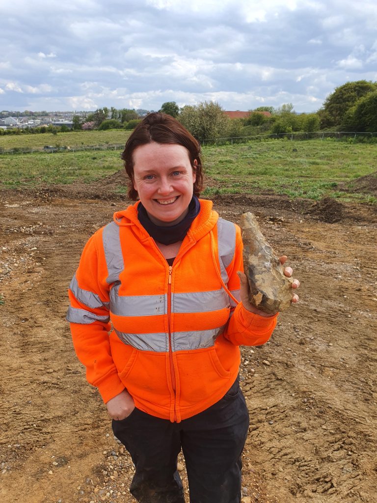 Letty Ingrey Holds Up One of the Handaxes on Site