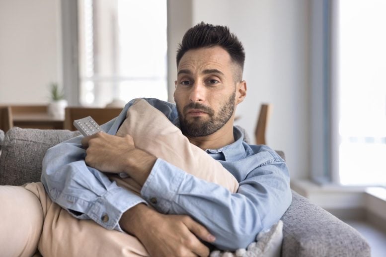 Lonely Young Man Hugging Pillow