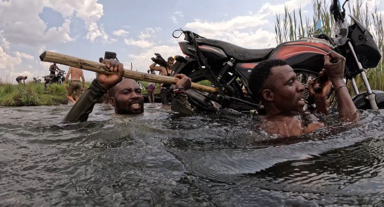 Luchazi Tribal Hunters Carry a Motorcycle