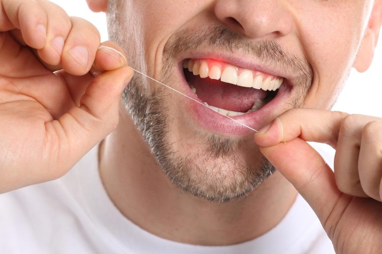 Man Flossing Teeth