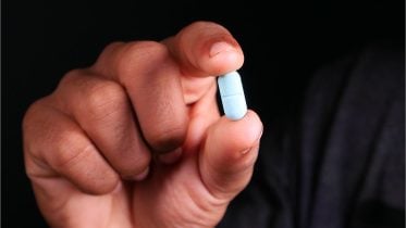 Man Holding a Pill Medicine Drug
