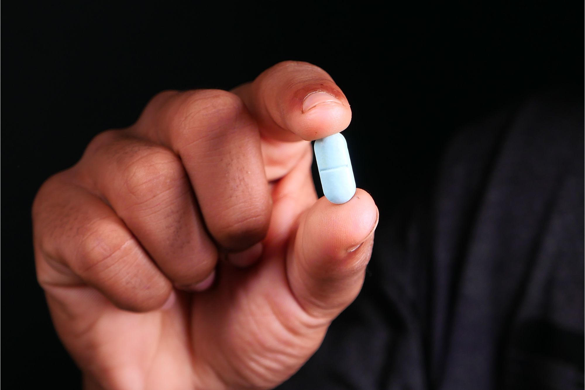 Man Holding a Pill Medicine Drug