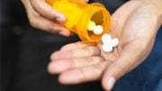 Man Pouring Drugs into Hand Medicine Aspirin