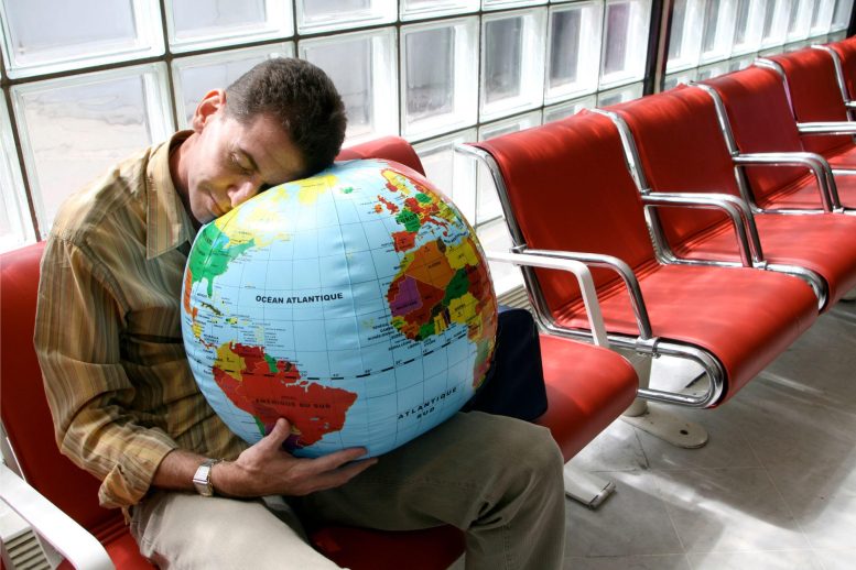 Man Sleeping Airport Globe