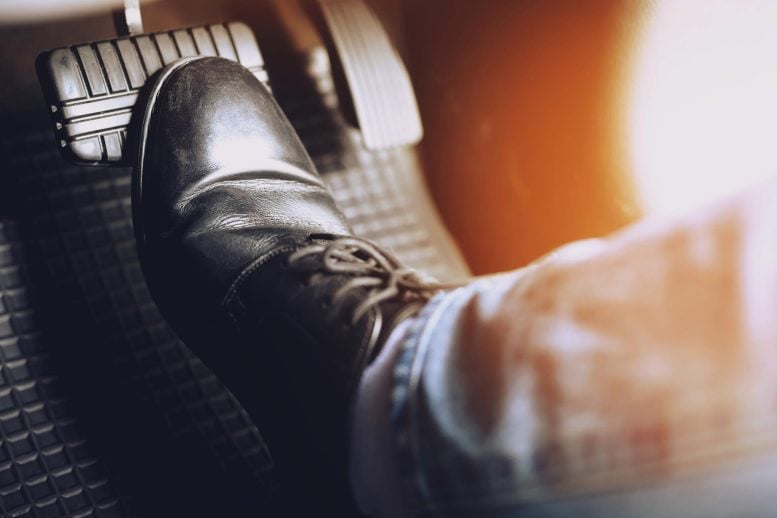 Man Stepping on Brake Pedal