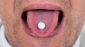 Man Taking Pill Tongue