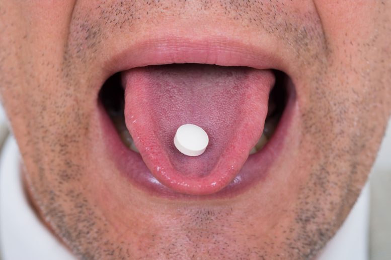 Man Taking Pill Tongue