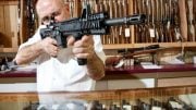 Merchant With Rifle in Gun Shop