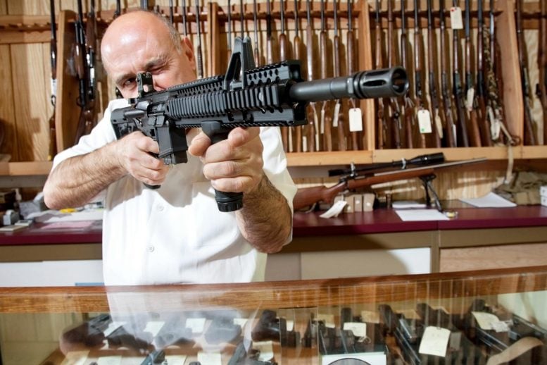 Merchant With Rifle in Gun Shop