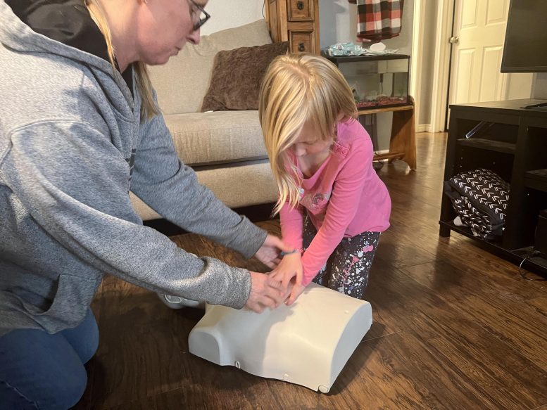 Mom Showing Daughter Proper CPR Form